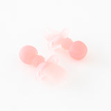 Bumkins Silicone Chewtensils®: Pink Jelly are displayed on a white background with one face-down, showcasing sensory bumps on the back.
