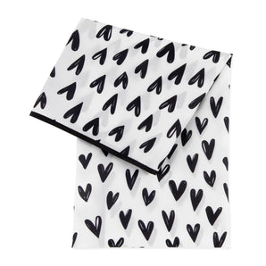 Bumkins Splat Mat: Hearts—white waterproof fabric with black heart pattern and trim with an easy-wipe surface.