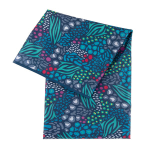 Bumkins Splat Mat: Animal Prints—abstract animal print pattern in blue, green, red, and white on dark waterproof fabric.