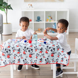 Two young children enjoy arts and crafts at a table covered by Bumkins Splat Mat: Mickey Mouse in a bright playroom.