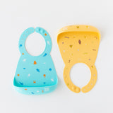Bumkins Silicone Bib 2 Pack: Ocean Life and Camp Gear is neatly arranged on a white background.