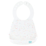 Bumkins Silicone Bib: Vanilla Sprinkle features a white silicone bib with a rainbow confetti pattern, adjustable neck closure, and pocket.