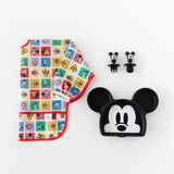 Bumkins Sleeved Bib: Mickey & Friends Check Mates is shown folded on a white background next to a Mickey-shaped plate and matching utensils.