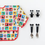 Bumkins Sleeved Bib: Mickey & Friends Check Mates is shown on a white background with two sets of Mickey-shaped utensils.