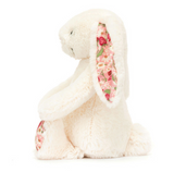 Side view of Jellycats Blossom Bunny Berry Little, featuring fluffy white fur with floral patterned ears and feet.