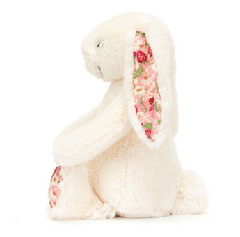 Side view of Jellycats Blossom Bunny Berry Little, featuring fluffy white fur with floral patterned ears and feet.