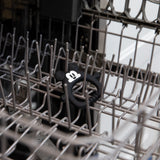 Bumkins Silicone Flat Teether: Mickey Mouse sits in the top rack of an open dishwasher.