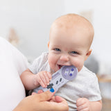 A baby is playfully biting a Bumkins Silicone Teether: Nintendo SNES™ Controller while held by someone with blue-painted nails.