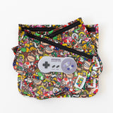 Bumkins Silicone Teether: Nintendo SNES™ Controller sits on top of colorful waterproof pouches on a white background.