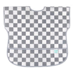 Bumkins Junior Bib: Charcoal Check features gray and white checkered, easy-wipe waterproof fabric, with pocket at the bottom.