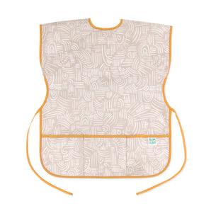 Bumkins Short-Sleeved Smock: Wander features beige waterproof fabric with a white abstract pattern, orange trim, adjustable ties and a pocket.