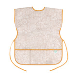 Bumkins Short-Sleeved Smock: Wander features beige waterproof fabric with a white abstract pattern, orange trim, adjustable ties and a pocket.