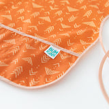 Close-up of Bumkins Short-Sleeved Smock: Grounded on a white background, with focus on the pocket.