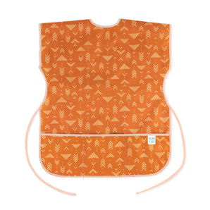 Bumkins Short-Sleeved Smock: Grounded features a white geometric pattern on orange waterproof fabric with an adjustable tie waist.