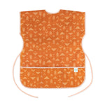 Bumkins Short-Sleeved Smock: Grounded features a white geometric pattern on orange waterproof fabric with an adjustable tie waist.