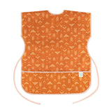 Bumkins Short-Sleeved Smock: Grounded features a white geometric pattern on orange waterproof fabric with an adjustable tie waist.