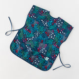 Bumkins Short-Sleeved Smock: Animal Prints lays flat on a white background.