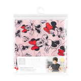 Bumkins Short-Sleeved Smock: Minnie Mouse Classic is shown folded in plastic packaging bag with a hanger and cardboard insert.