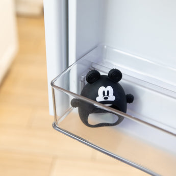 Bumkins Silicone Un-Droppable Mitt Teether: Mickey Mouse sits in a clear fridge door compartment.