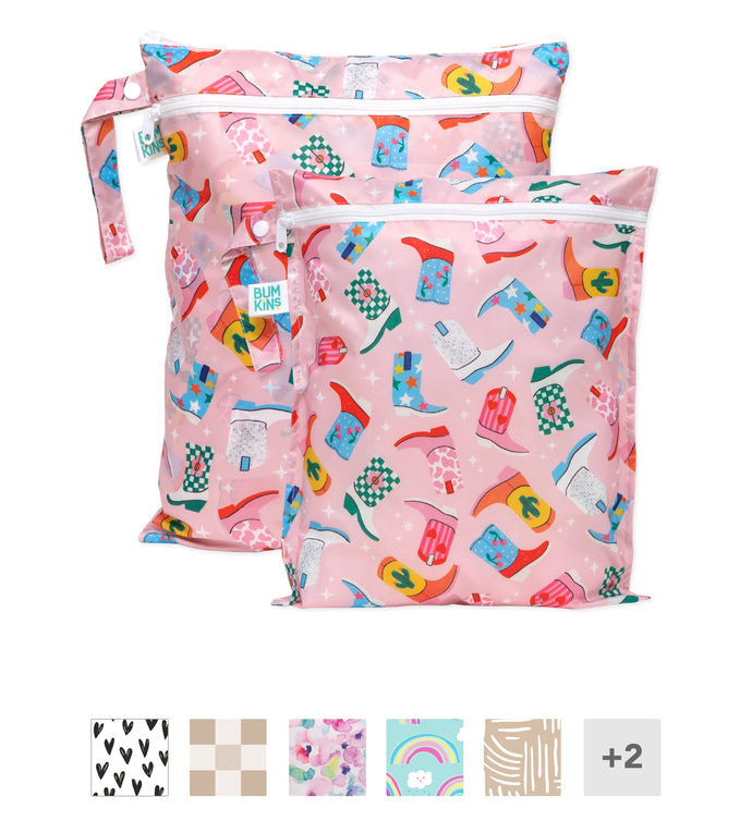 Two pink zippered wet bags with colorful cowboy hat patterns, shown with small preview swatches of other available designs below.