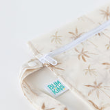 Close-up of Bumkins Wet Bag: Palm Daze, featuring a palm tree pattern and white zipper; a waterproof, eco-friendly choice.
