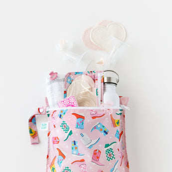 Two bags from Bumkins The Playdate Planner Deluxe 5-Piece Set: Boots hold breast pump parts and a water bottle on a white background.