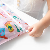 A child's hand unzips a Bumkins Wet Bag: Boots, crafted from colorful and waterproof fabric and designed for reuse.