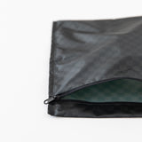 Roamio by Bumkins Wet Bag: Rich Black lays partially open on a white background, revealing the interior.