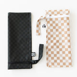 Bumkins Wet Bag 2 Pack: Sand and Black Check lays folded on a white background.