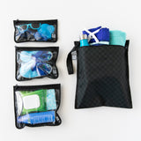 Bumkins Bumkins The Chaos Coordinator Essential 4-Piece Set: Rich Black is neatly arranged on a white background, holding swim gear.