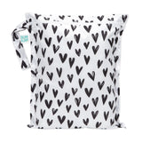 Bumkins Wet Bag: Hearts features a black heart pattern on white waterproof fabric, a zipper closure, and side handle.