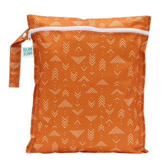 Bumkins Wet Bag: Grounded features orange waterproof fabric with white geometric patterns and a durable white zipper.
