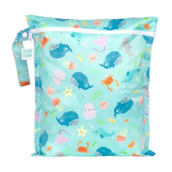 Bumkins Wet Bag: Ocean Life features sea creatures on blue waterproof fabric, with a zipper closure and side handle.