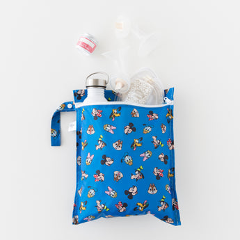 A bag from Bumkins Wet Bag + Wet/Dry Bag Set: Mickey & Friends Forever holds essentials like a bottle & breast pump parts on a white background.
