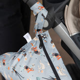 Close-up of a stroller with Bumkins Wet Bag: No Tricks, Just Treats, featuring Halloween ghosts and pumpkins, hanging from the handle.