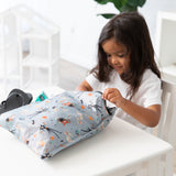 Young child opens a Bumkins Wet Bag 2 Pack: Disney Everyday Is Halloween, made from waterproof fabric, indoors.