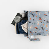 Bumkins Wet Bag: No Tricks, Just Treats holds a book, water bottle, blue jeans, and a light shirt on a white background.