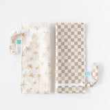 Bumkins Wet Bag 2 Pack: Palm Check—one with a palm design and another in beige checks lay folded next to each other on a white background.