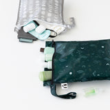 Roamio by Bumkins Wet Bag 2 Pack: Desert Night—one holds bottles & pads, the other stores mini toiletries & sanitizer.