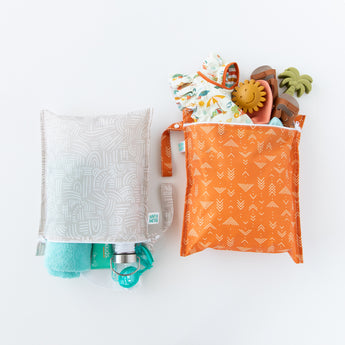Bumkins Wet Bag 2 Pack Wander + Grounded lays on a white background with both bags side-by-side, holding beach essentials.