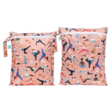 The Bumkins Wet Bag + Wet/Dry Bag Set: Yoga Pals features two pink, eco-friendly, reusable packing bags with playful yoga prints.