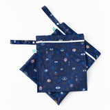 The Bumkins Wet Bag + Wet/Dry Bag Set: Evil Eye features navy bags with mystical eyes—stylish diapering essentials.
