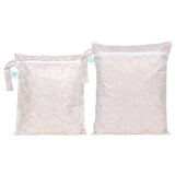 Bumkins Wet Bag + Wet/Dry Bag Set: Wander—2 beige waterproof bags with white abstract patterns and zipper closures.