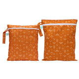 Bumkins Wet Bag + Wet/Dry Bag Set: Grounded—orange, reusable, eco-friendly bags with white arrows and blue tags for outings.