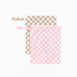 Bumkins Wet Bag Plus 2 Pack: Mauve + Sand Check lays overlapped on a white background.