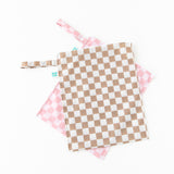 Bumkins Wet Bag Plus 2 Pack: Mauve + Sand Check lays stacked on a white background.
