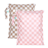 Bumkins Wet Bag Plus 2 Pack: Mauve + Sand Check includes 2 waterproof checkered bags in tan and pink with zipper closures and side handles.