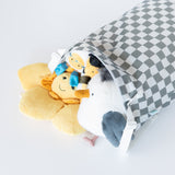 Bumkins Extra Large Wet Bag: Charcoal Check holds plush toys on a white background.