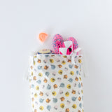 Bumkins Extra Large Wet Bag: Winnie + Friends holds a ball and pink sneakers; an orange mouthguard is nearby on a white background.