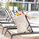 Bumkins Extra Large Wet Bag: Winnie + Friends filled with beach essentials hangs from an empty lounge chair near a pool.